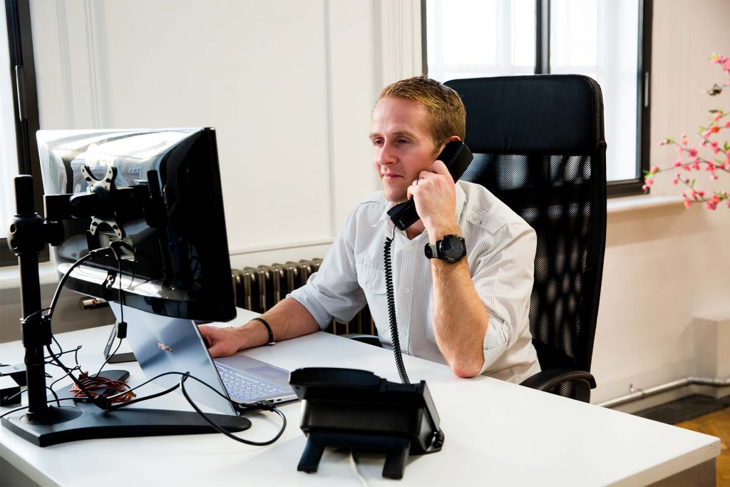 Chris at his desk taking a phone call