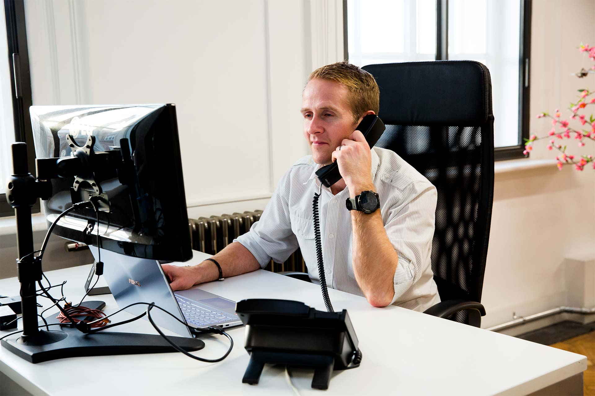 Chris at his desk taking a phone call