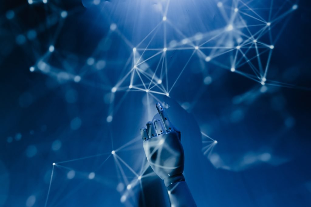 A blue image of a pair of hands and dots of light and lines.