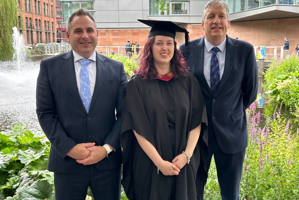 A photo of Jess with Mike and Ian at her graduation